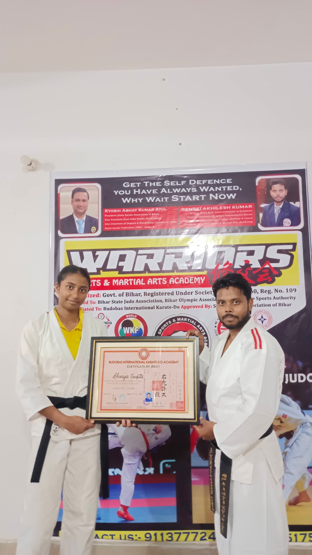 Activity Zone student receiving Budobas International Karate-Do black belt 1st Dan certificate from Rensei Akhilesh Kumar
